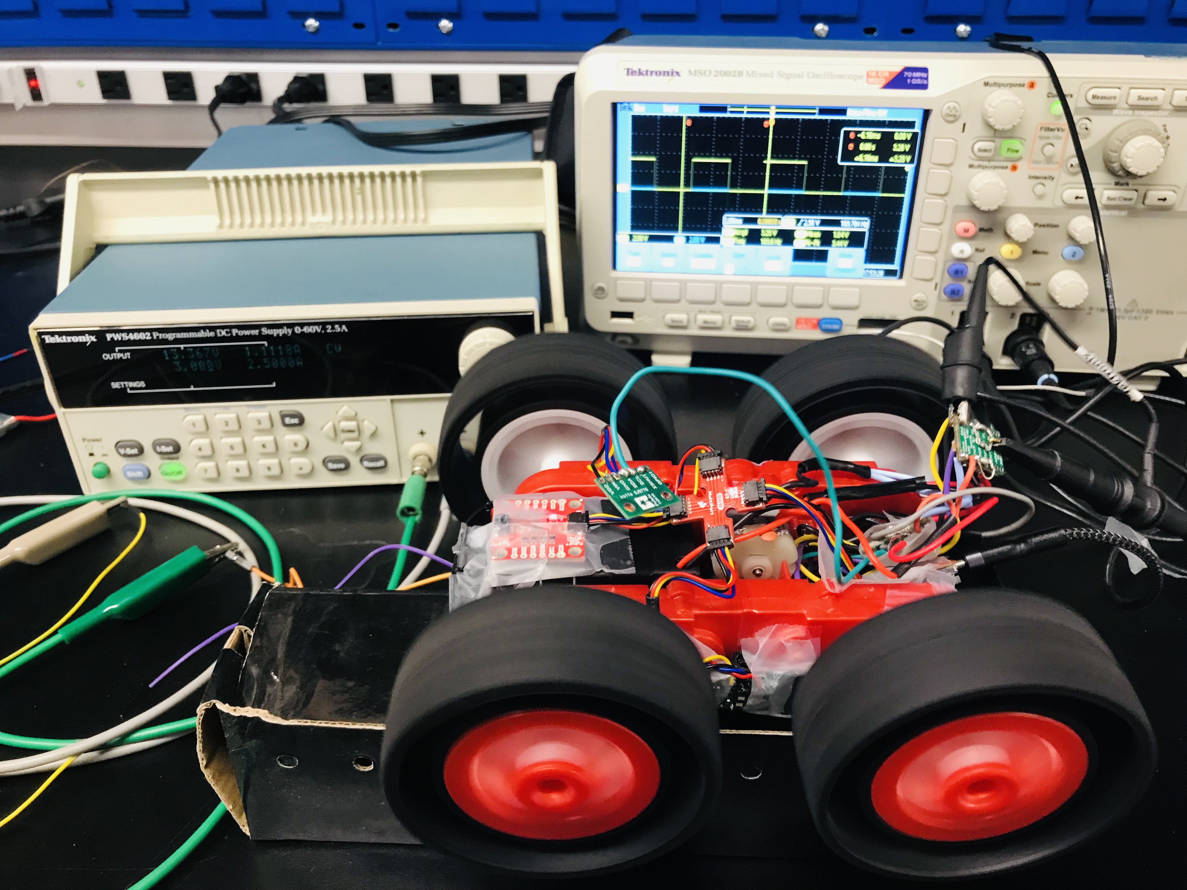 Picture of the oscilloscope setup. The oscilloscope is displaying a 50% duty cycle PWM signal from the Artemis.