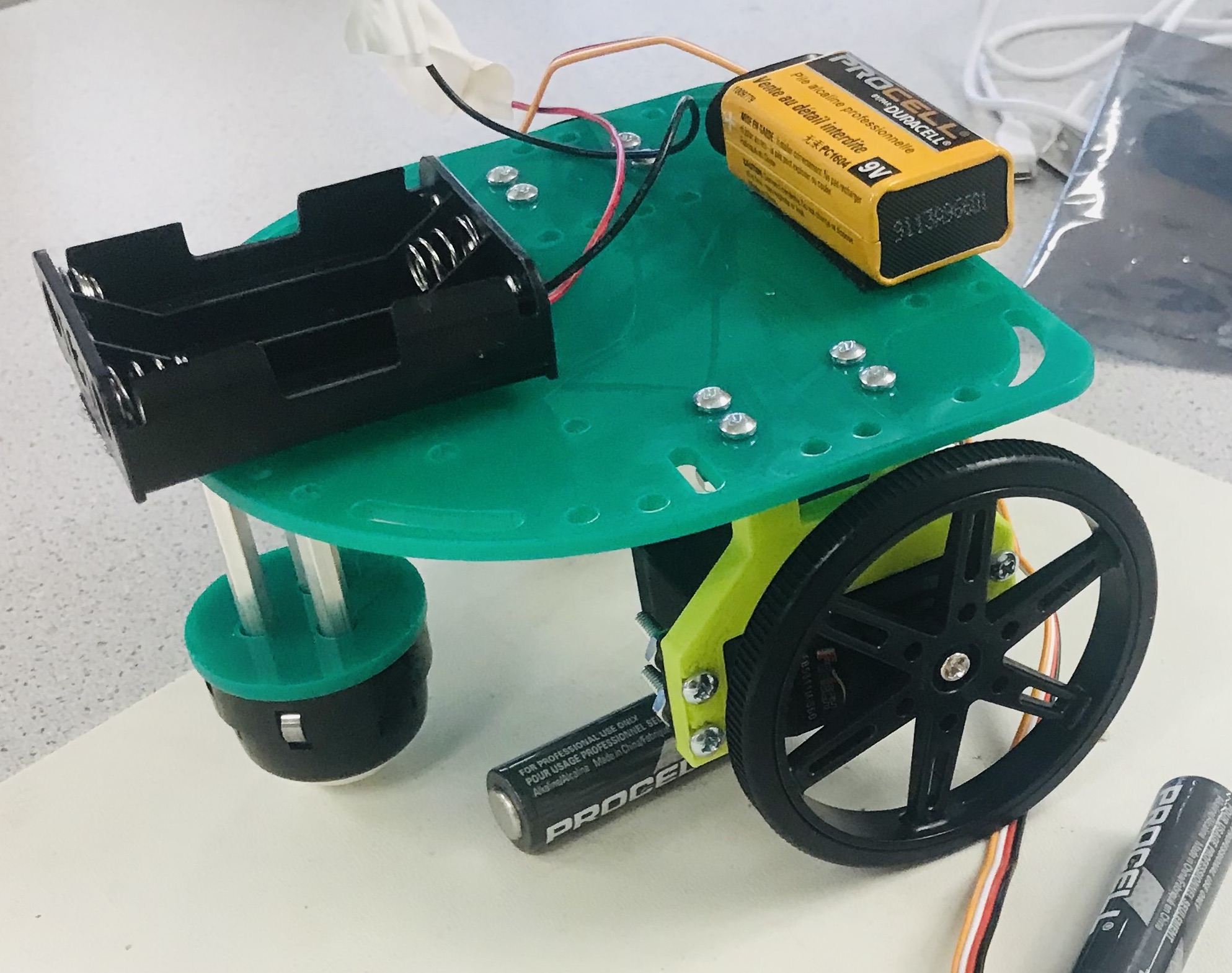 Frame with servos, wheels, and batteries on